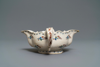 A polychrome Brussels faience '&agrave; la haie fleurie' sauce boat, 18th C.